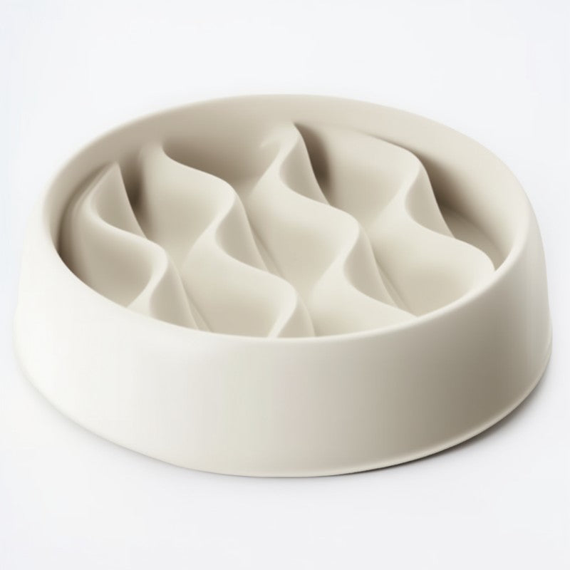Beige ceramic pet bowl with divided sections on a white background