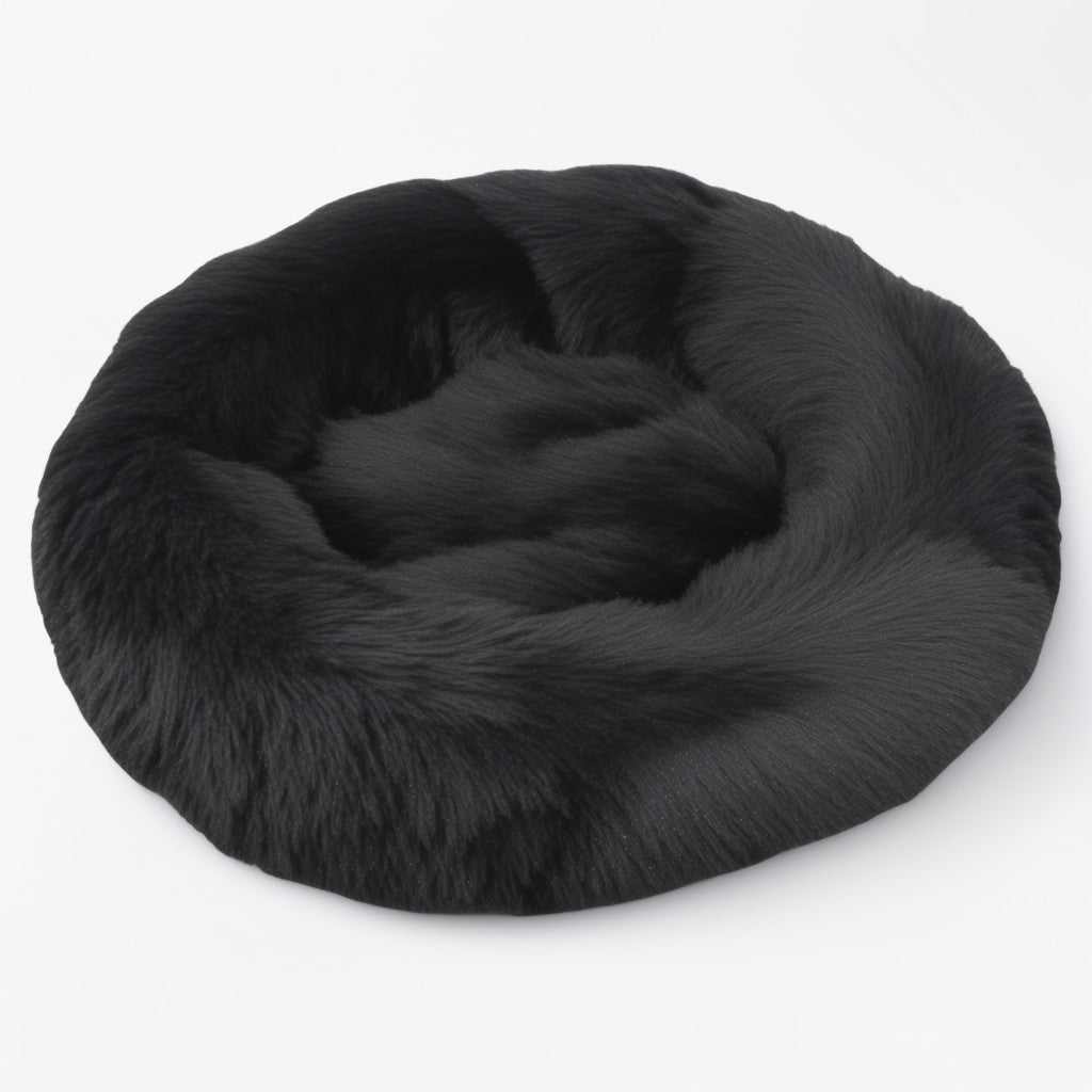 Black plush calming donut bed for dogs and cats, cozy round design with supportive bolstered edges.