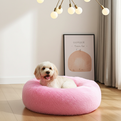 Dog lying on a pink fluffy pet bed in a room with a light-colored wall and framed picture.