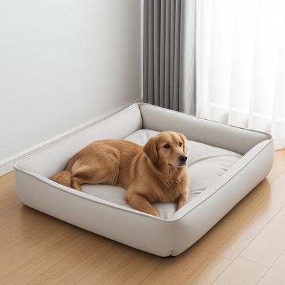 Dog lying on a large white pet bed in a room with light wood flooring and white walls.