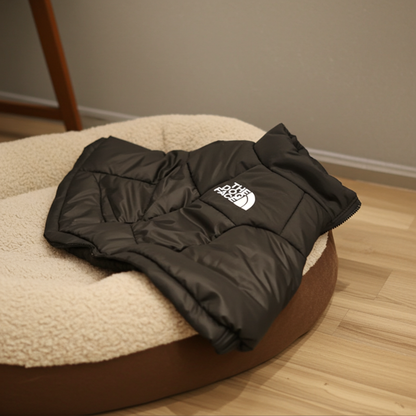 Black puffer jacket with a logo on a round cushioned chair.