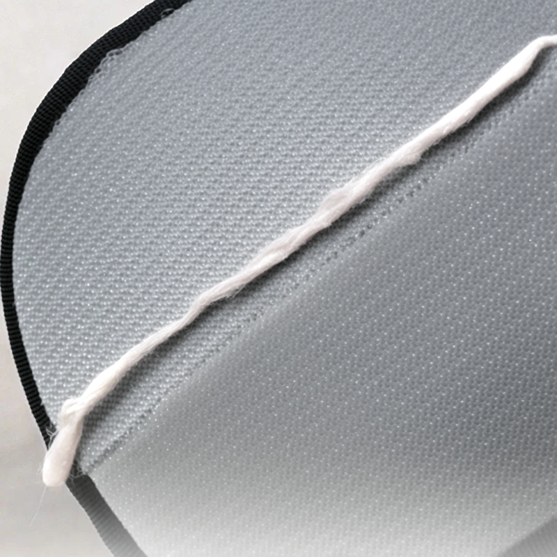 Close-up of a gray fabric surface with a white line and black border.