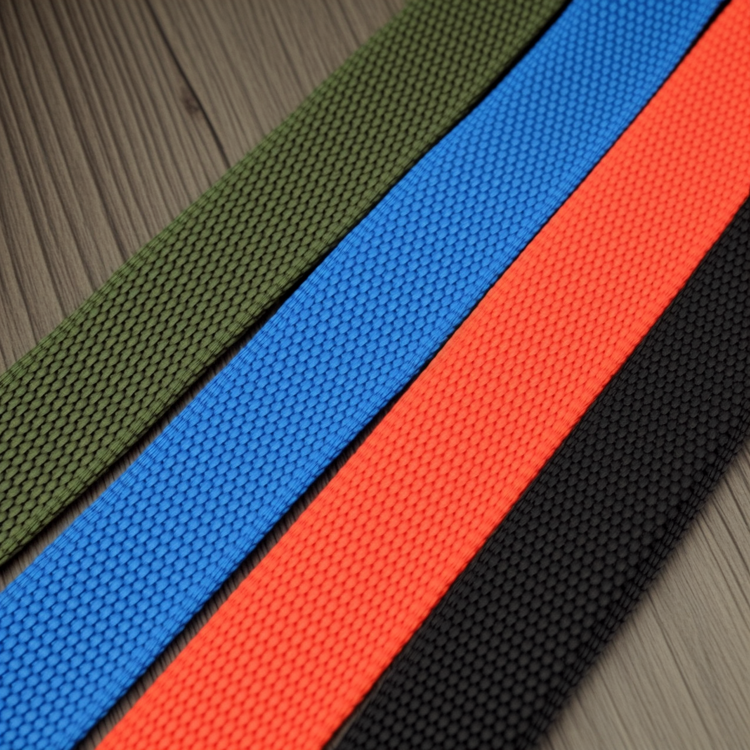 Four colorful belts (green, blue, orange, black) laid out on a textured surface.