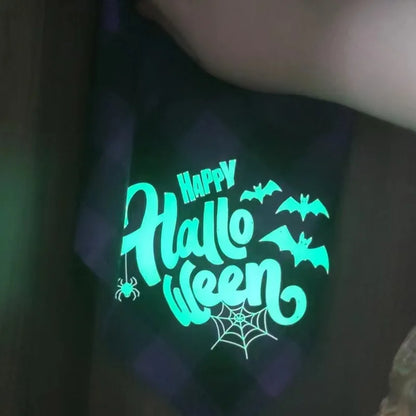 Glowing 'Happy Halloween' text with bats and spider webs on a dark background