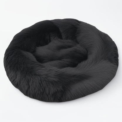 Black plush calming donut bed for dogs and cats, cozy round design with supportive bolstered edges.