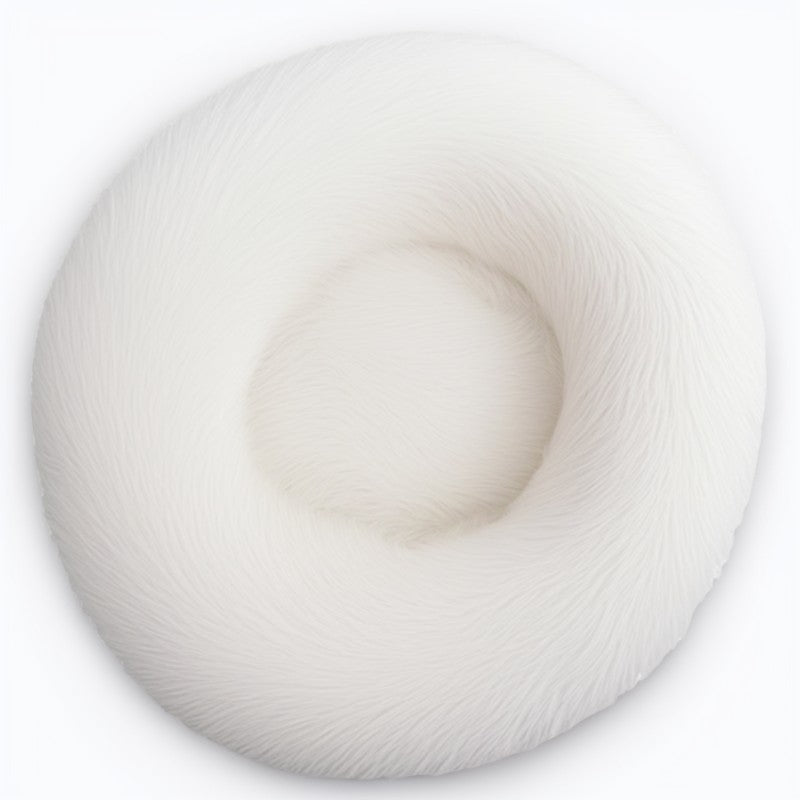 White fluffy calming pet bed in donut shape, ideal for deep sleep and relaxation for pets.