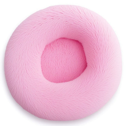 Bright pink round calming bed for dogs and cats, fluffy plush design perfect for cuddly naps.