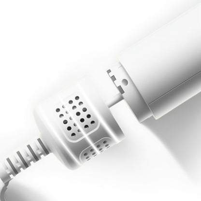 Close-up of a white electronic device with a cable on a light gray background