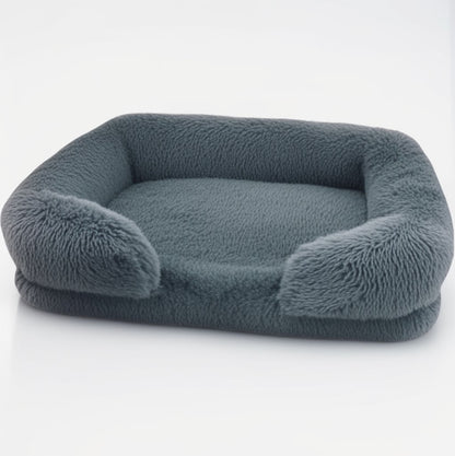 Charcoal grey sofa-style furry dog bed — rectangular plush design with bolster sides and anti-slip base.