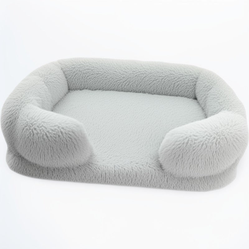 Light grey sofa-style furry dog bed — rectangular plush pet sofa with soft bolsters and washable cover.
