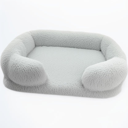 Light grey sofa-style furry dog bed — rectangular plush pet sofa with soft bolsters and washable cover.