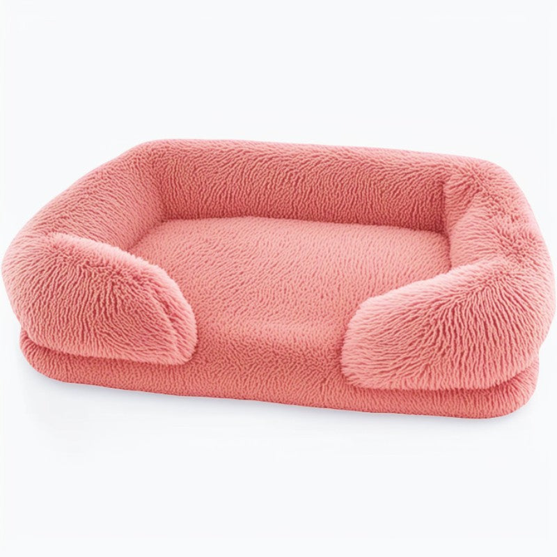 Pink sofa-style furry dog bed — rectangular plush pet sofa with supportive bolsters and cushioned memory-sponge layer.