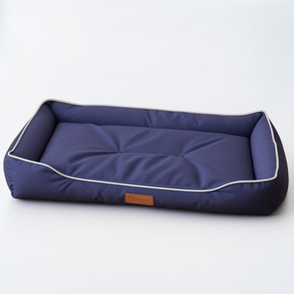 Navy blue waterproof dog bed with thick cushioned bolsters and minimalist design.