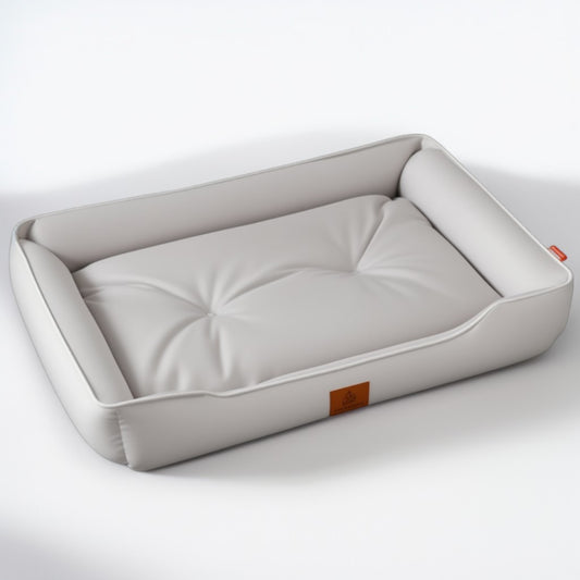 Light grey waterproof dog bed with soft padded surface and raised bolsters.