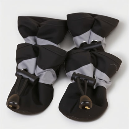 Black and gray pet shoes with bows on a white background