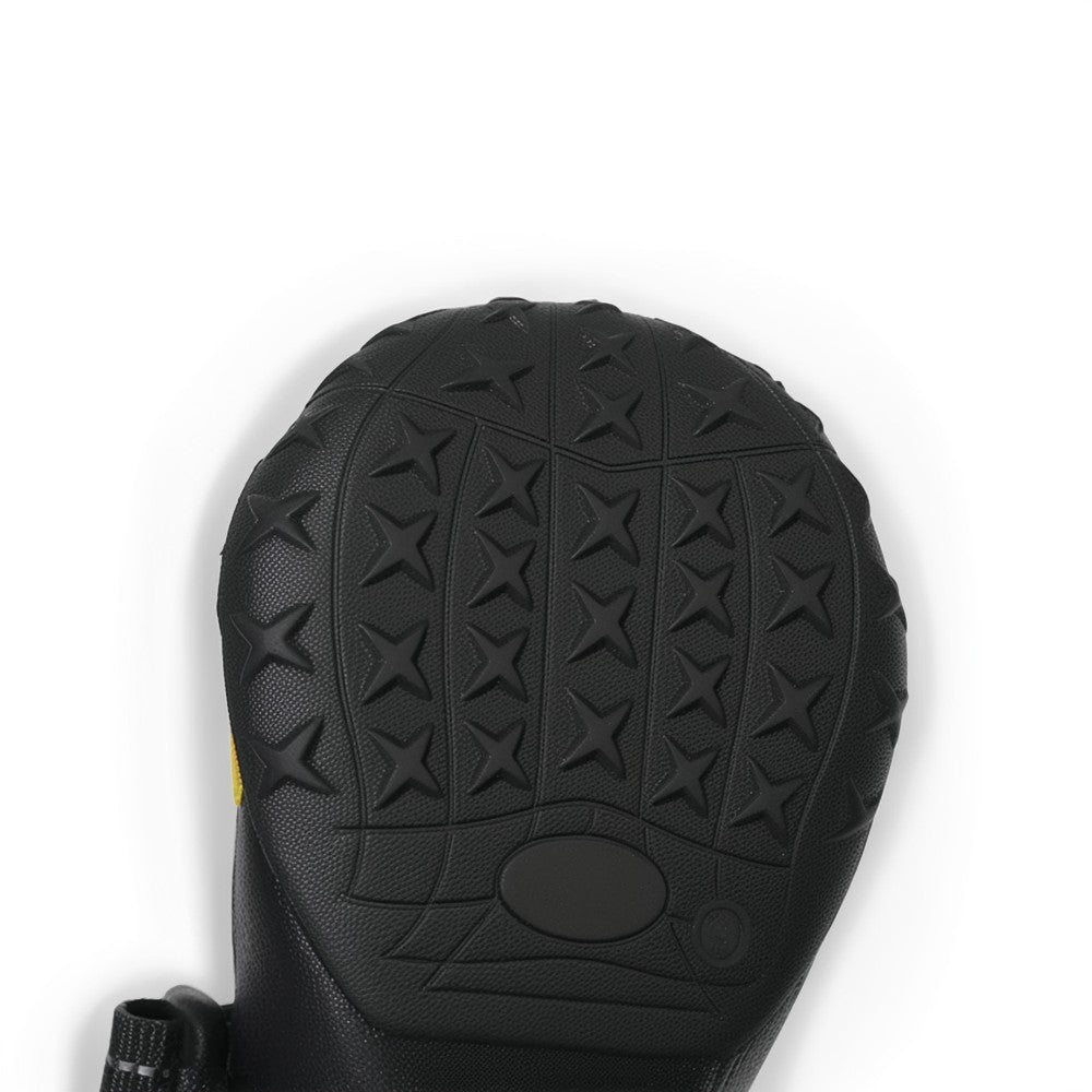 Close-up of a black boot sole with star-patterned tread on a white background